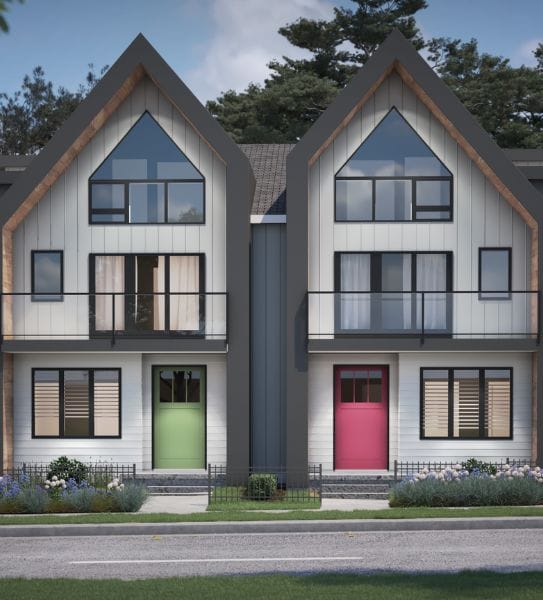 A modern duplex building with white siding, featuring two distinct triangular roofs crafted by expert home designers. One entrance door is green and the other is red, with large windows above each door.