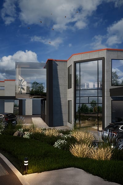 This custom home design features large glass windows and concrete walls, seamlessly blending with the landscaped garden. Birds fly gracefully in the blue, cloudy sky overhead, a testament to the building designers' innovative vision.